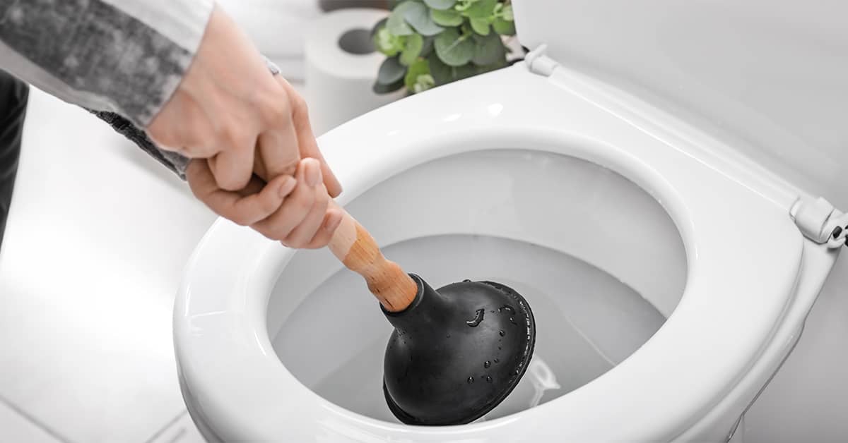 DIY toilet unblocking with plunger in action, showcasing effective clog removal.