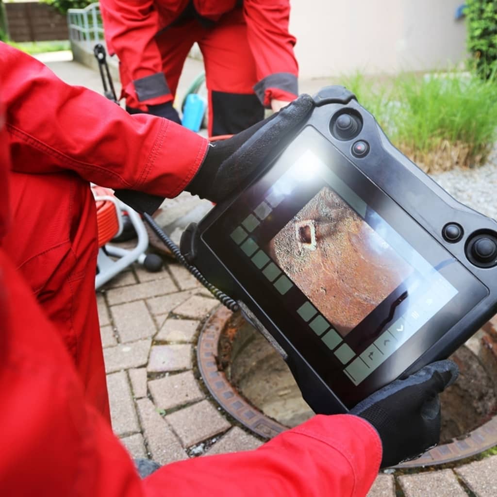 Technician using a camera to inspect a drain.