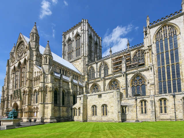 York Minster, a famous Gothic cathedral in York, standing against a clear blue sky. Unblockers.net provides expert drain unblocking services across York to keep your drainage system flowing smoothly.