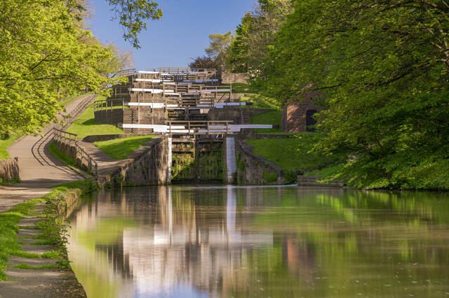 Bingley Five Rise Locks on a sunny day, surrounded by greenery and calm canal water. Unblockers.net provides professional drain unblocking services across Bingley with fast response times and fixed pricing.