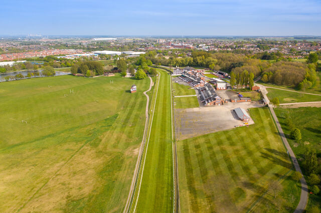Aerial photo of Pontefract Racecourse surrounded by open green fields in West Yorkshire. Unblockers.net offers professional, fixed-price drain unblocking services across Pontefract for homes and businesses.