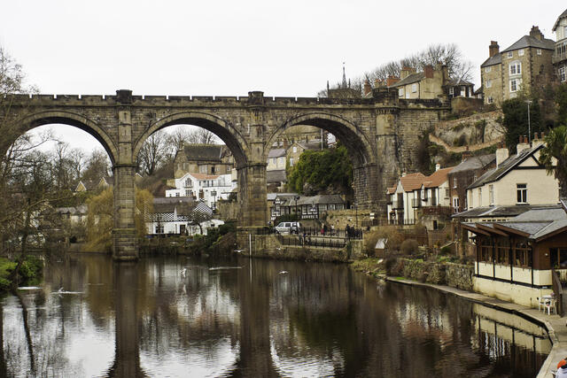 Knaresborough Viaduct and riverside buildings reflected in the River Nidd. Unblockers.net provides professional, fixed-price drain unblocking services across Knaresborough with round-the-clock availability.